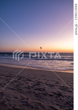 Sunset view of Scarborough Beach in Perth, Australia. with silhouette of a person kitesurfing or skysurfing, surf with a parachute Sunset view of Scarborough Beach in Perth, Australia. with silhouette of a person kitesurfing or skysurfing, surf with a parachute 139813089