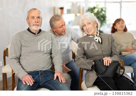 Elderly people listening and talking to each other during group presentation 139815362