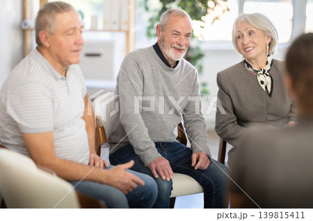 Engaged elderly people sitting in a circle and talking 139815411