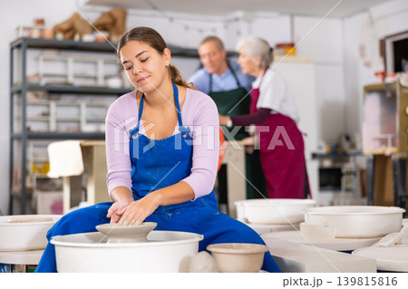 girl works with potter wheel 139815816