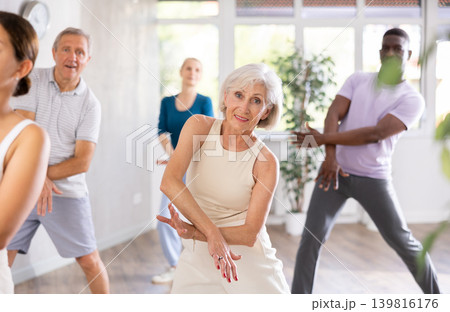 Senior woman dances learn to move energetically to beat of music Senior woman dances learn to move energetically to beat of music 139816176