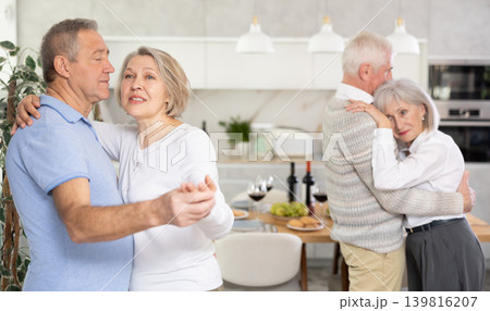 Couple of elderly man and woman dancing in kitchen Couple of elderly man and woman dancing in kitchen 139816207