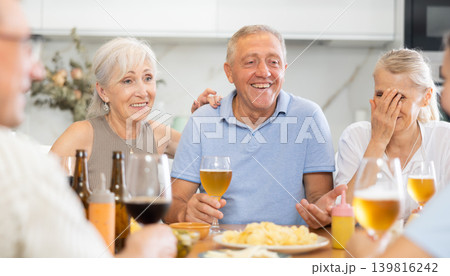 Elderly people drinking and chatting at table 139816242