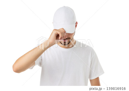 Young man adjusts his cap while wearing a shirt, PNG Young man adjusts his cap while wearing a shirt, PNG 139816916