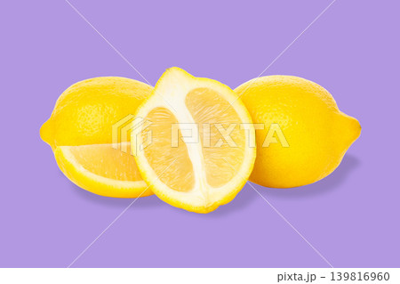 Three fresh lemons with one cut in half showing the inside Three fresh lemons with one cut in half showing the inside 139816960