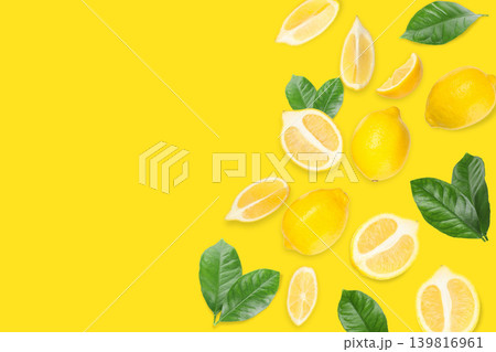Fresh yellow lemons with green leaves arranged together Fresh yellow lemons with green leaves arranged together 139816961