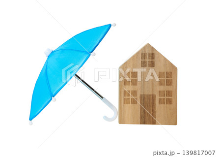 Blue umbrella near a wooden house symbolizes insurance, isolated, PNG 139817007