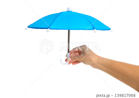 Hand holds small blue umbrella for coverage options, isolated, PNG Hand holds small blue umbrella for coverage options, isolated, PNG 139817008