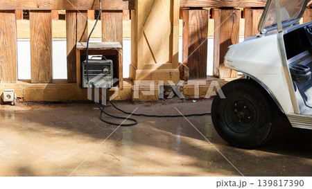 Charging an electric golf car at home Charging an electric golf car at home 139817390
