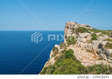 Dramatic rocky cliffside view overlooking the Mediterranean Sea in Mallorca, Spain with rugged Dramatic rocky cliffside view overlooking the Mediterranean Sea in Mallorca, Spain with rugged 139818041