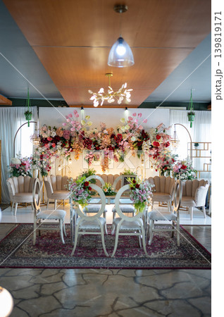 Elegant wedding stage decoration with akad table and beautiful floral backdrop at luxury indoor venue 139819171