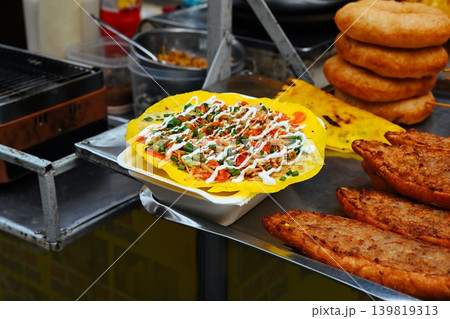 A freshly made Banh Trang Nuong known as Vietnamese pizza is displayed on a street food stall counter in Hoi An Quang Nam province Vietnam 139819313