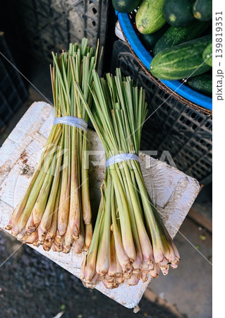 A vertical close up view of fresh green lemongrass bunch displayed on a white foam box at a traditional street market stall in Vietnam A vertical close up view of fresh green lemongrass bunch displayed on a white foam box at a traditional street market stall in Vietnam 139819351