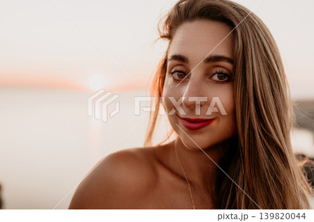Woman sunset beach smiling portrait of a young lady at the seashore during golden hour with ocean background 139820044
