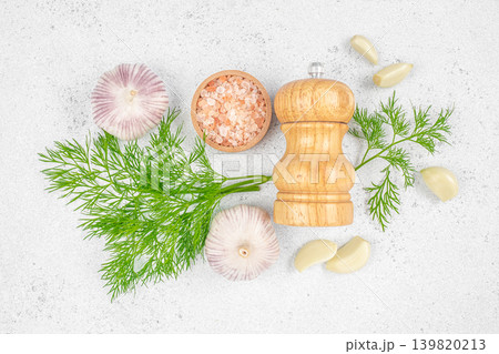 Dill garlic salt and pepper grinder on white background top view Dill garlic salt and pepper grinder on white background top view 139820213