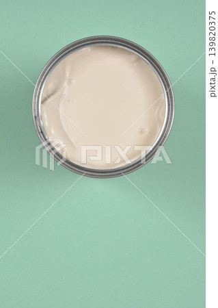 Opened Can of Coconut Milk on Green Background Opened Can of Coconut Milk on Green Background 139820375