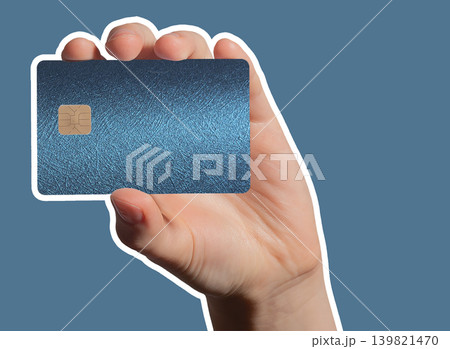 Hand holding blue plastic bank card for cashless payment. Hand holding blue plastic bank card for cashless payment. 139821470