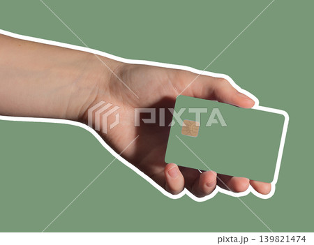 Hand holding green bank card for cashless payment. 139821474