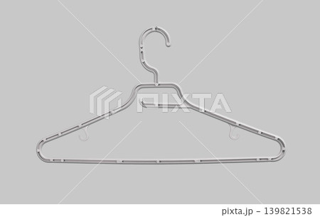 Transparent plastic hanger isolated on light background. Clothing support accessory with hook and shoulder frame. Wardrobe storage object for garment hanging.. 139821538