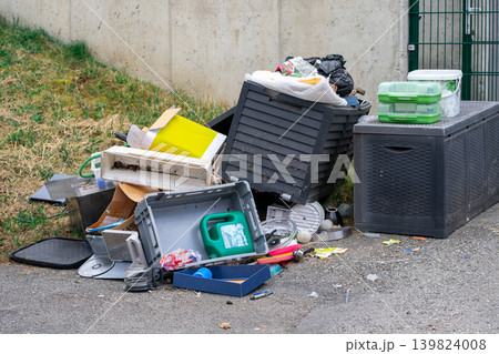 View of various discarded garbage on the street. Garbage on a city street View of various discarded garbage on the street. Garbage on a city street 139824008