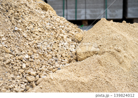 Piles of rubble at a construction site against the background of paving slabs Piles of rubble at a construction site against the background of paving slabs 139824012