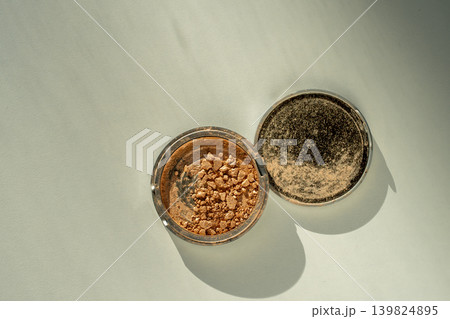 Broken palette with highlighter on a white table. Decorative cosmetics Broken palette with highlighter on a white table. Decorative cosmetics 139824895