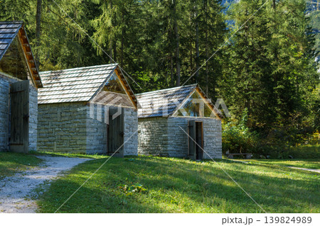 Several stone brick mountain houses with a wooden roof in the Austrian Alps Several stone brick mountain houses with a wooden roof in the Austrian Alps 139824989