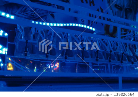 Clear containers with beverages, lit by bright blue led lights at night 139826564