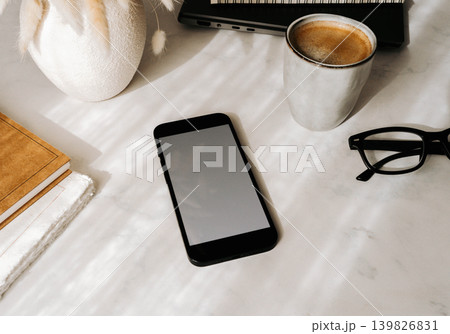 Minimal workspace flat lay with smartphone mock up, coffee, glasses and notebooks 139826831