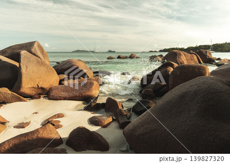 A serene coastal scene with massive boulders along a sandy shore. Praslin, Seychelles A serene coastal scene with massive boulders along a sandy shore. Praslin, Seychelles 139827320