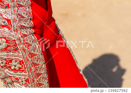 The leg of a typical bullfighter costume in a bullfight	 139827562