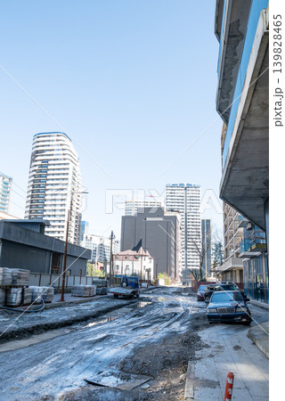 Urban street under construction with modern highrise buildings in daylight. Urban street under construction with modern highrise buildings in daylight. 139828465