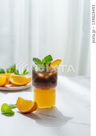 Cold bumble coffee with orange juice and ice on marble background 139828493