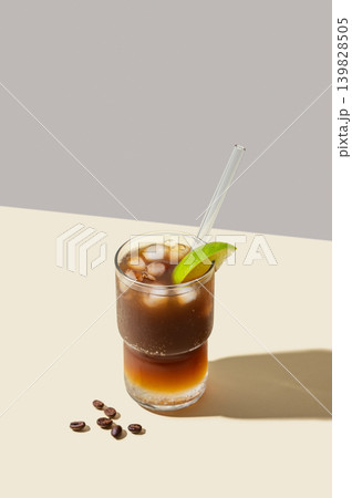 Cold Coffee Tonic Drink With Lime and Ice on light background with shadows 139828505
