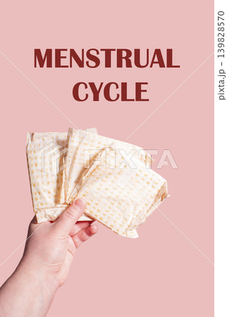 Classic menstrual pads in woman hand. Menstrual cycle and suffering from menstrual pain. Female period and intimate hygiene Classic menstrual pads in woman hand. Menstrual cycle and suffering from menstrual pain. Female period and intimate hygiene 139828570