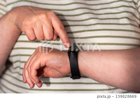 Smartwatch showing heart rate. Calm health tracking. Quiet shift from health anxiety to relaxed informed awareness. Human calm over digital urgency 139828669