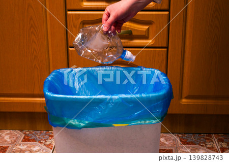 Woman putting used plastic bottle in waste bin, separate waste collection and recycling concept. High quality photo Woman putting used plastic bottle in waste bin, separate waste collection and recycling concept. High quality photo 139828743