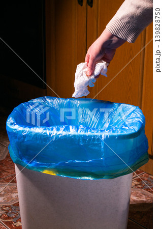 Woman putting paper in waste bin, separate waste collection and recycling concept Woman putting paper in waste bin, separate waste collection and recycling concept 139828750