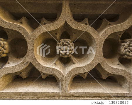 Detailed Stone Carving Architectural Ornament With Floral Rosette And Gothic Tracery On Historic Sandstone Facade, Granada Detailed Stone Carving Architectural Ornament With Floral Rosette And Gothic Tracery On Historic Sandstone Facade, Granada 139828955