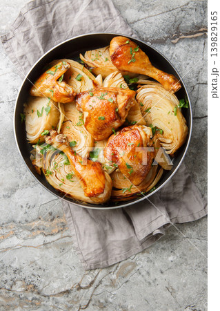 Spicy roasted chicken with chopped cabbage, cooked food in a rustic style as a background closeup on the table. Vertical top view 139829165