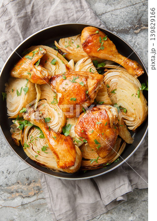 Baked chicken pieces with cabbage in soy sauce and honey close-up in a frying pan. Vertical top view 139829166