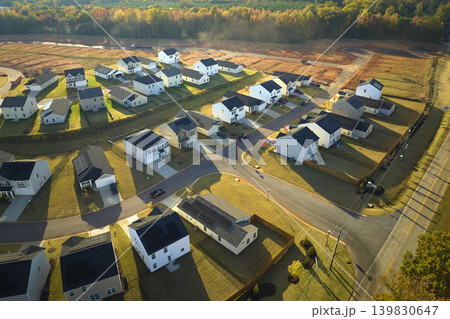 View from above of densely built residential houses in living area in South Carolina. American dream homes as example of real estate development in US suburbs View from above of densely built residential houses in living area in South Carolina. American dream homes as example of real estate development in US suburbs 139830647