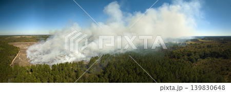 View from above of dense smoke from woodland and field on fire rising up polluting air. Concept of natural disaster 139830648