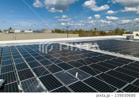 Photovoltaic solar panels destroyed by hurricane strong wind mounted on industrial building roof for producing green ecological electricity. Consequences of natural disaster in Florida Photovoltaic solar panels destroyed by hurricane strong wind mounted on industrial building roof for producing green ecological electricity. Consequences of natural disaster in Florida 139830680