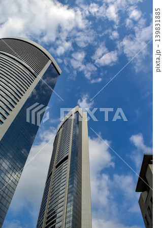 Low angle view of skyscapers of Hong Kong. Hong Kong cityscape. Modern Buildings. Building exterior. Travel concept. Low angle view of skyscapers of Hong Kong. Hong Kong cityscape. Modern Buildings. Building exterior. Travel concept. 139831885