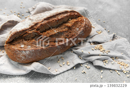 Rustic rye sourdough bread loaf on gray cloth 139832229