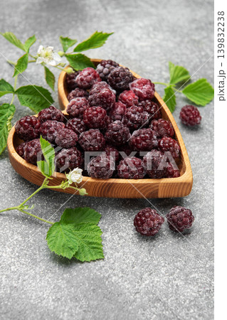 Frozen blackberries in heart shaped wooden bowl Frozen blackberries in heart shaped wooden bowl 139832238