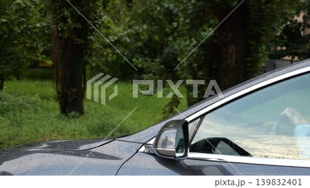 Modern electrical automobile driving at urban road on rainy day. Ecology friendly car riding moving along motorway. Electric vehicle riding through empty highway. Concept of green innovation. Slow mo 139832401