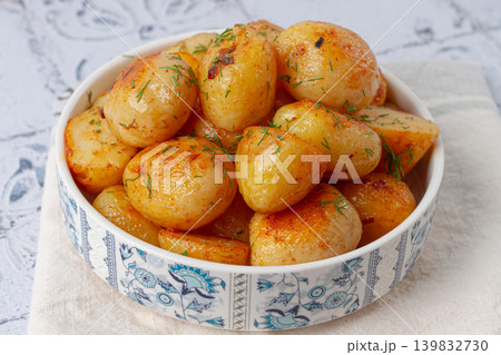 Baked new potatoes, with butter and dill, on a white plate, at home, no people, Baked new potatoes, with butter and dill, on a white plate, at home, no people, 139832730