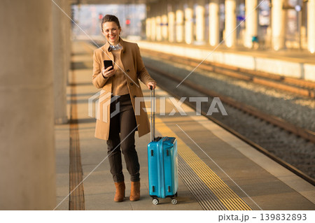 Smiling Woman Walking with Suitcase on Platform 139832893